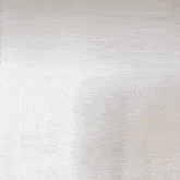 a woman is standing in front of a white wall and looking at the camera .