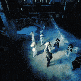 a group of people are standing on a stage with smoke coming out of it