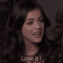 a close up of a woman 's face with the words `` love it '' next to her .