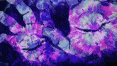 a close up of a person 's hands with purple and blue paint on them