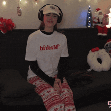 a woman wearing headphones and a shirt that says bibsm