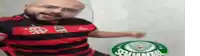 a bald man with a beard wearing a red and black striped shirt