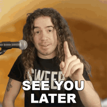 a man with long hair and a black shirt that says ' weed see you later ' on it