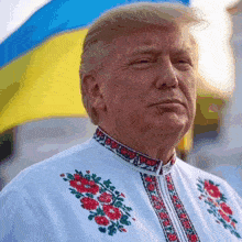 donald trump is wearing a white shirt with red and green flowers on the collar
