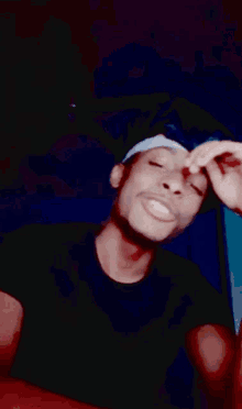 a man wearing sunglasses and a white hat is making a hand gesture
