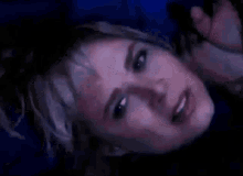 a close up of a woman 's face with her mouth open