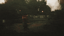 a blurry picture of a person walking in a field