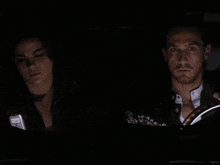 a close up of a woman 's face with her eyes closed in a dark room .