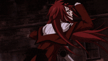 a man with long red hair is wearing a black vest