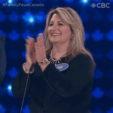 a woman with a name tag that says ama is clapping