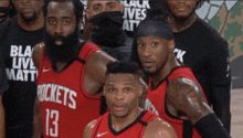 a group of basketball players are posing for a photo and one of them is wearing a jersey that says rockets 13