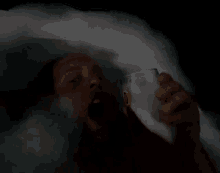 a person is laying in a bathtub with foam on their head