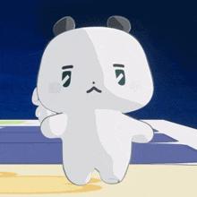 a cartoon panda bear with a sad face is standing on a table