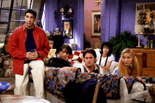 a group of people sitting on a couch in front of a sign that says aux bluttes