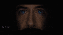 a close up of a person 's face with the word filmy on the bottom left