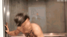 a blurry picture of a shirtless man in an elevator with the website sobeh.tumblr.com in the lower right corner