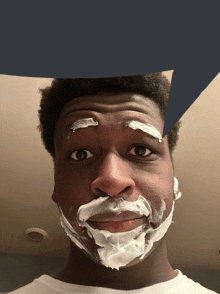 a man with shaving cream on his face