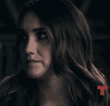 a close up of a woman 's face with a red arrow pointing to the left