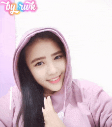 a girl wearing a purple hoodie with the word by rwk on the bottom