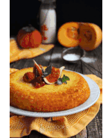 a cake with figs and berries on top of it