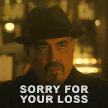 a man in a hat says sorry for your loss in white letters