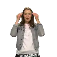 a woman wearing a denim jacket has the word dasding on her waist