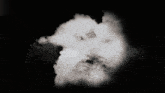 a black and white photo of a cloud in a dark sky