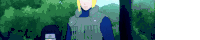 a man with blonde hair is standing in a forest wearing a green vest .
