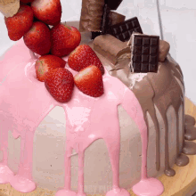 a cake with pink frosting and strawberries on top has easy pink written on the bottom