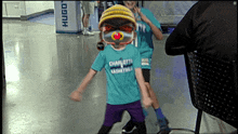 a little girl wearing a charlotte basketball shirt
