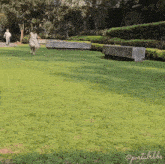 a girl in a white dress is running in a park with the words portalbibs on the bottom