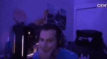 a man wearing headphones looks at the camera in a dark room with the word gent on the bottom right