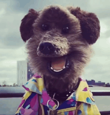 a stuffed animal dog wearing a colorful shirt and collar
