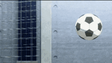 a soccer ball is flying in the air near a fence