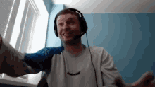 a man wearing headphones and a shirt that has the word babolat on it