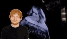 a man with red hair is standing in front of a screen