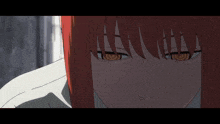 a close up of a girl 's face with red hair