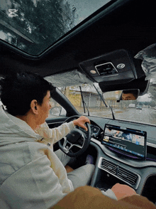 a man is driving a car with a screen that says youtube
