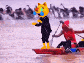 a yellow cat mascot is standing on a boat that says ' silly ' on it