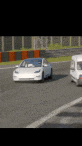 a white tesla model 3 is driving on a race track next to a white van