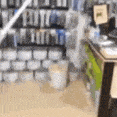 a blurred image of a store with a lot of boxes on the shelves