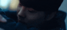 a close up of a man 's face behind a broken glass window
