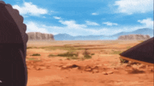 a blurry picture of a desert with mountains in the background