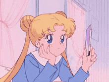 a girl is looking at herself in the mirror .