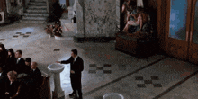a man in a suit stands in front of a sink in a church