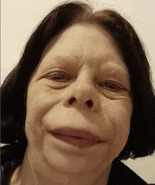a close up of a woman 's face with a very small nose