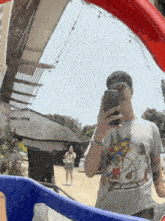 a man is taking a picture of himself in the mirror