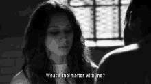 a black and white photo of a woman talking to a man and the words what 's the matter with me