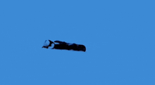 a person on a snowboard is going down a snowy hill