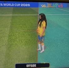 a soccer player is standing in front of a fifa world cup 2026 sign